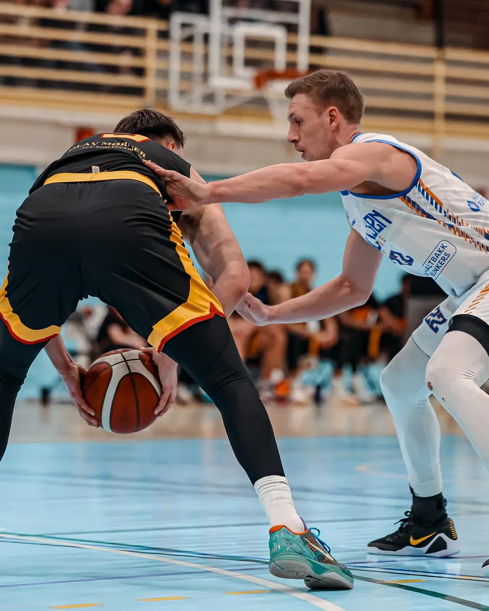 Nikolas on defence, low and tight on the ball handler